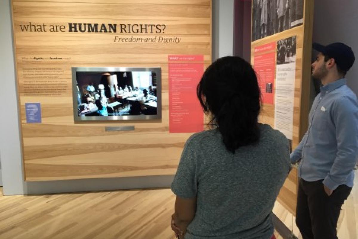 students looking at a display about human rights